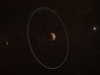 Artystyczna wizja Quaoar z jego pierścieniem i księżycem Weywotem | Image credit: By ESA, CC BY-SA IGO 3.0, CC BY-SA 3.0 igo, https://commons.wikimedia.org/w/index.php?curid=128528577