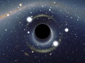 Symulowany widok czarnej dziury umieszczonej przed Wielkim Obłokiem Magellana. By User:Alain r (Own work) [CC BY-SA 2.5 (http://creativecommons.org/licenses/by-sa/2.5)], via Wikimedia Commons