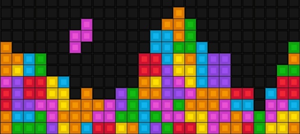 Kolorowe kostki na czarnym tle wzorowane na grze komputerowej "Tetris" | fot. Fotolia 